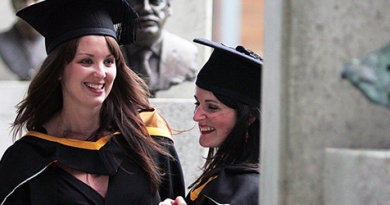 Two graduating students laughing