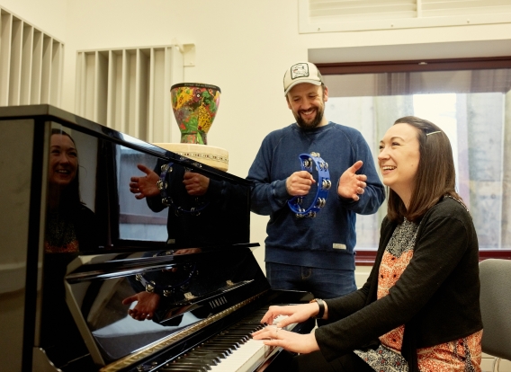 Music therapy students at a piano