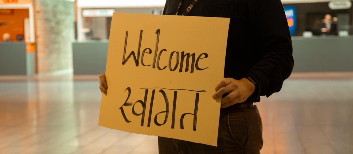 A welcome sign being held at Shannon Airport