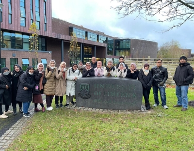 Group of Indonesian students standing outside of the library in the university of Limerick. 