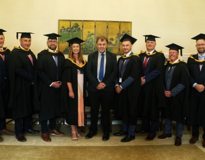 Professor Sean Arkins pictured with some of the first students to graduate with Masters Level Apprenticeships