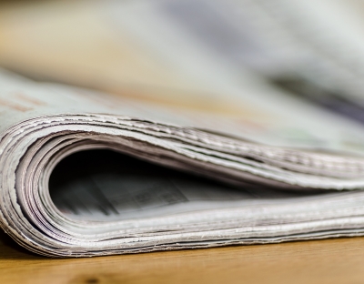 image shows newspapers in a bundle 