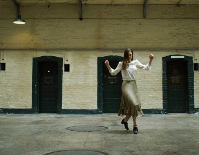 Student dances in front of doors