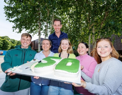Ryan Tubridy with students and the cake on the UL campus