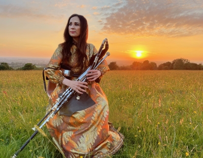louise playing instrument in a field