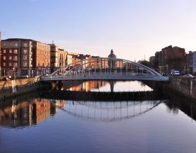 Ha'penny bridge, Dublin on clear day reflecting on the river
