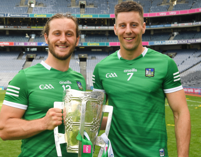 A photo of UL alumnus Dan Morrissey holding the Liam McCarthy Cup with Tom Morrissey