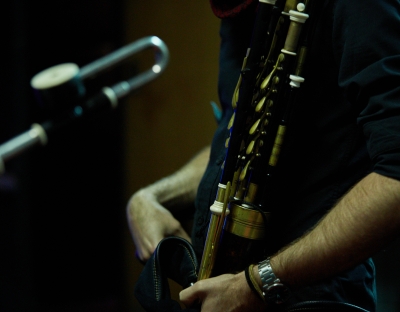 Person playing uilleann pipes