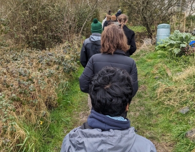 A group of students walking through the wilderness in Cloughjordan Eco Village