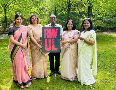MGM Uni delegates holding an RW UL sign