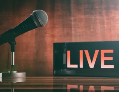 image of a microphone with an announcement saying 'live'