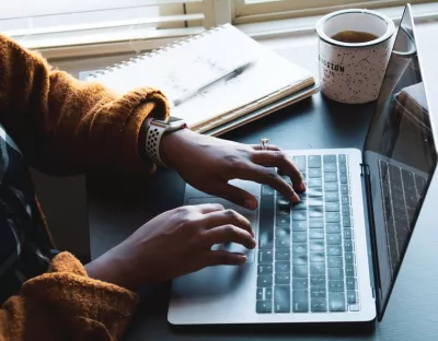Image of someone using their laptop to work at home