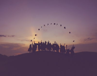 Image of graduates throwing their caps in the air 