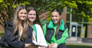 3 students sitting on a bench enjoying an Open Day