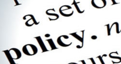 Close up of the definition of the word policy in dictionary