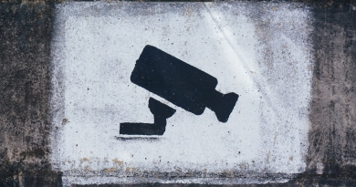 icon of camera sprayed onto a wall to indicate CCTV monitoring