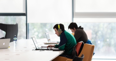 Image of two students on laptops in UL Library