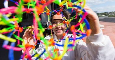Female science student with colourful expandable ball