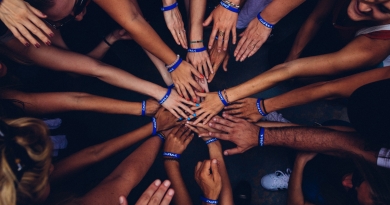 a group of hands stacked in a huddle