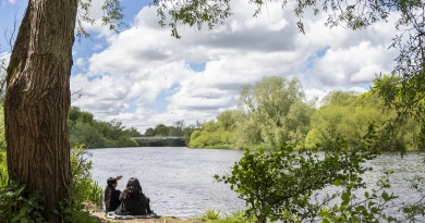 Students looking onto the River Shannon on the University of Limerick campus