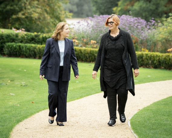 A picture of Ambassador Florence Ensch and President Kerstin Mey walking on campus