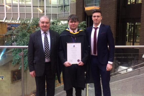Tomás at his MA graduation in 2018 with his father and brother 