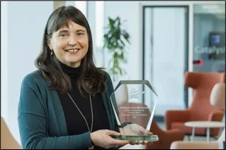 Anne MacFarlane holding Award
