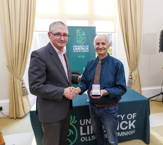 President Shane Kilcommins presenting the medal to Mickey Dunne