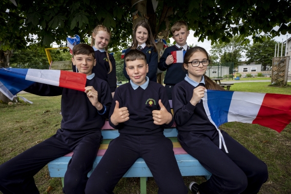 Graduated school pupils holding french flags.