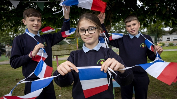 Graduated school pupils holding french flags.