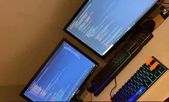 Two computer screens with Computer Science work