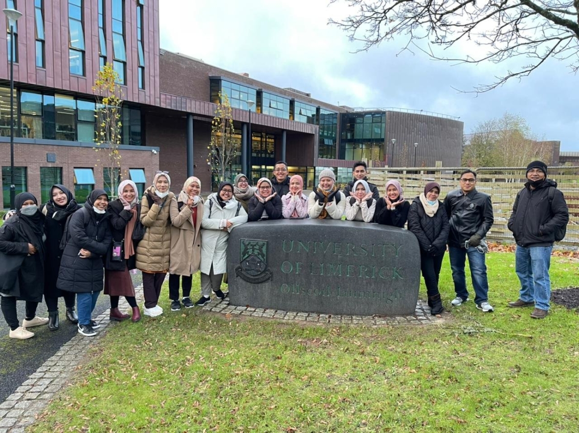 Group of Indonesian students standing outside of the library in the university of Limerick. 