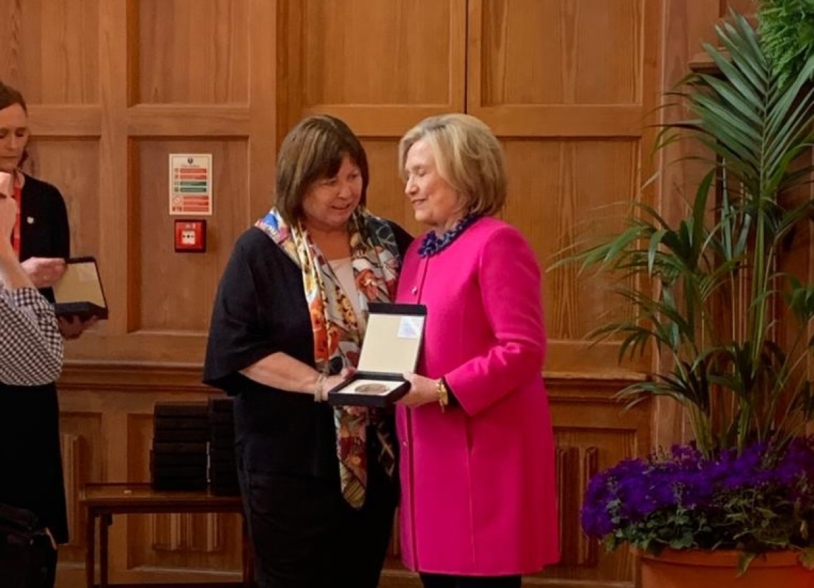 A picture of Mary Harney receiving her award from Hilary Clinton