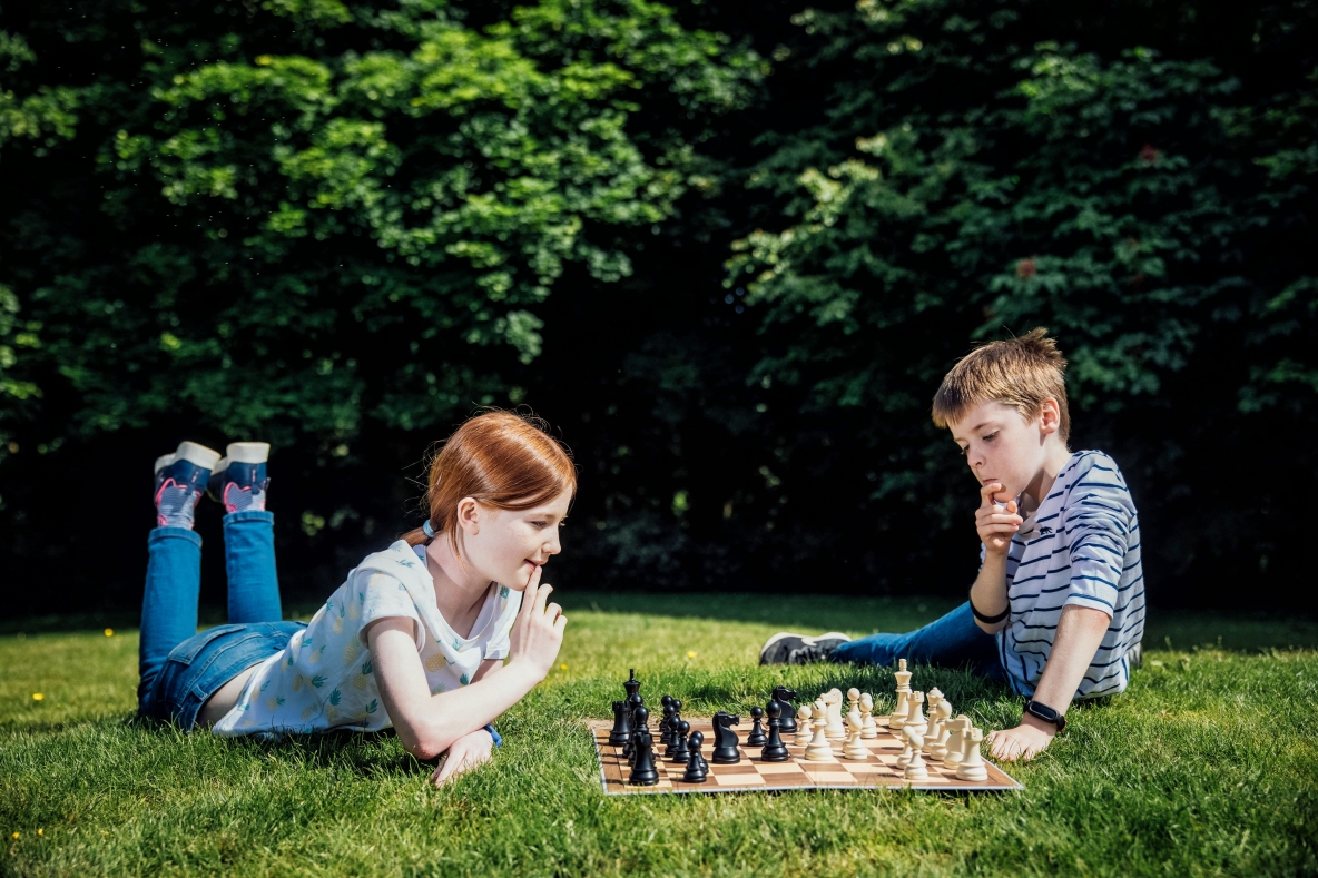 Two kids pictured playing chess at University of Limerick