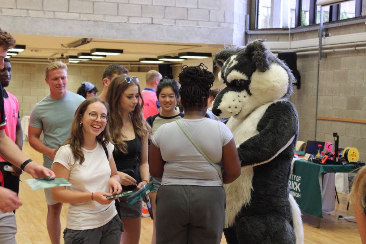 Photo of Wolfie with students at the Student Support fair for Orientation 2023