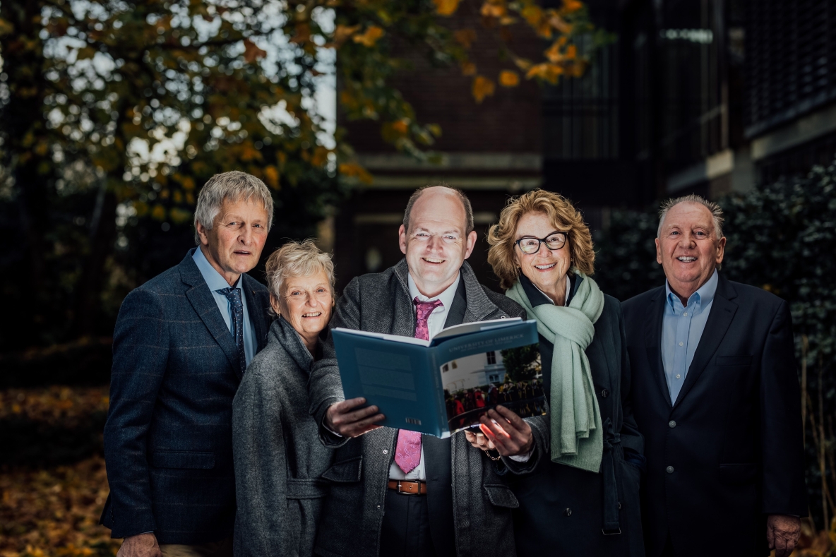 Some of UL's first graduates pictured with Martin Walsh, holding the book being launched on campus