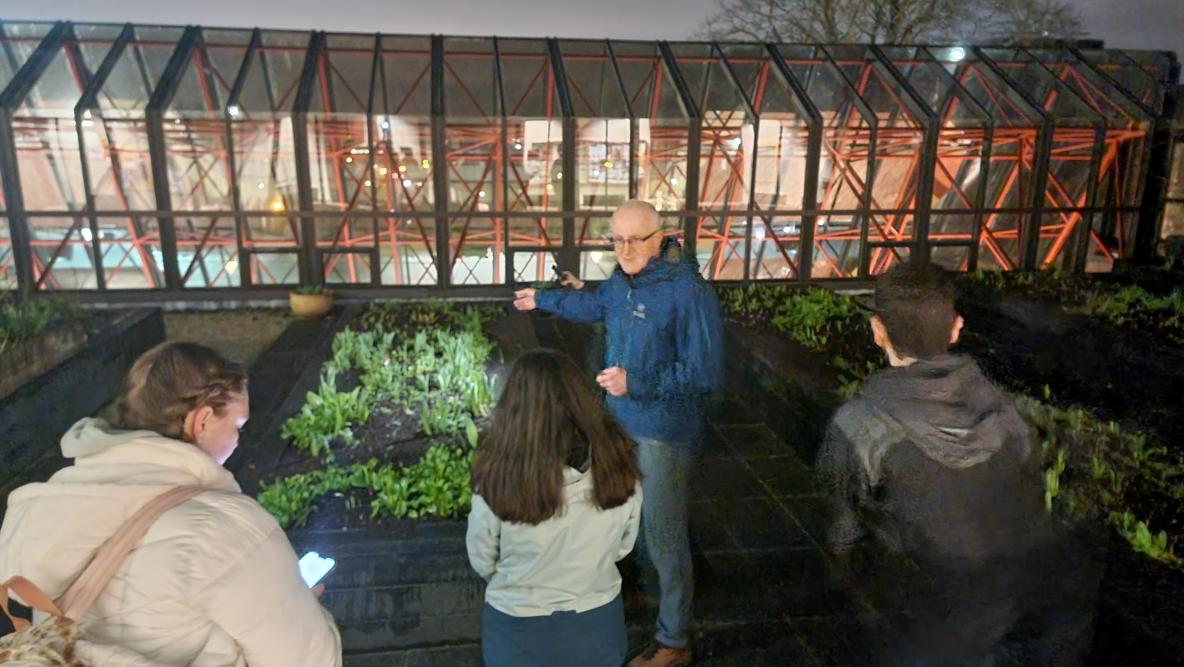 A nighttime photo of students and staff at the UL rooftop garden