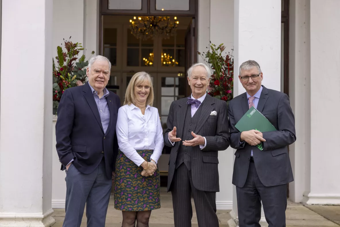 A group picture of four people standing outside Plassey House at UL