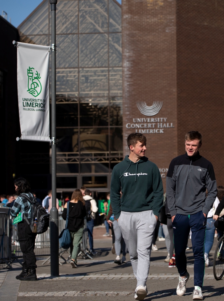 two young men walking outside the foundation building